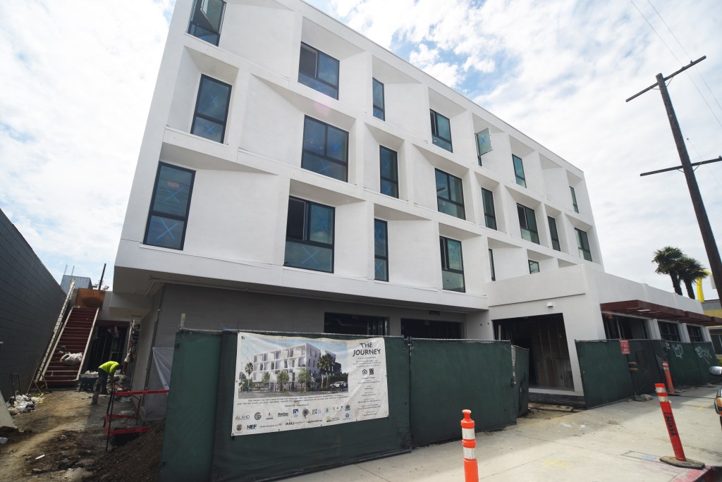 Four-story white apartment building